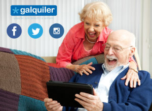 Senior couple laughing while using their tablet pc to video chat with their grandkids.